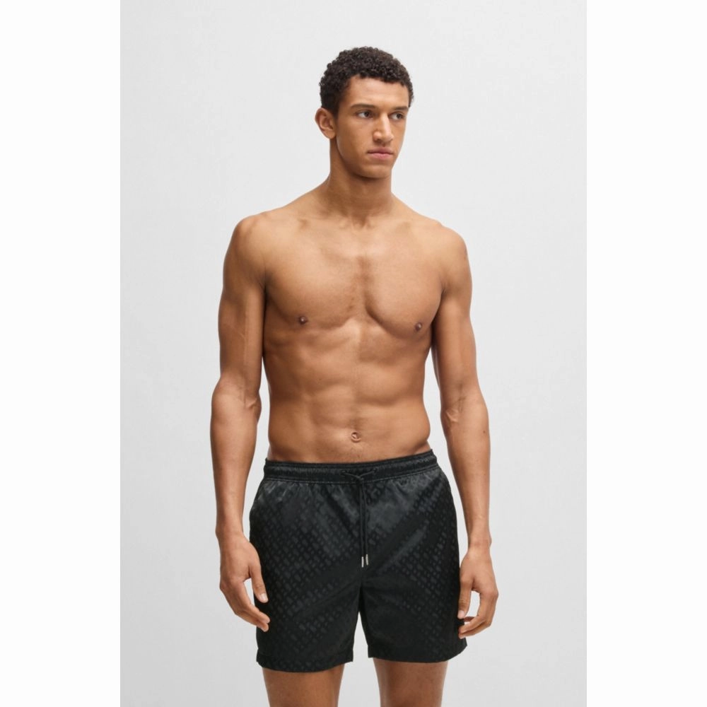 Swim shorts with all-over tonal monograms