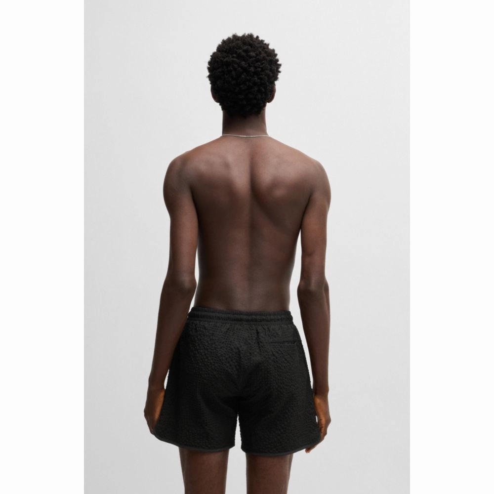 Waffle-structured swim shorts with embroidered stacked logo